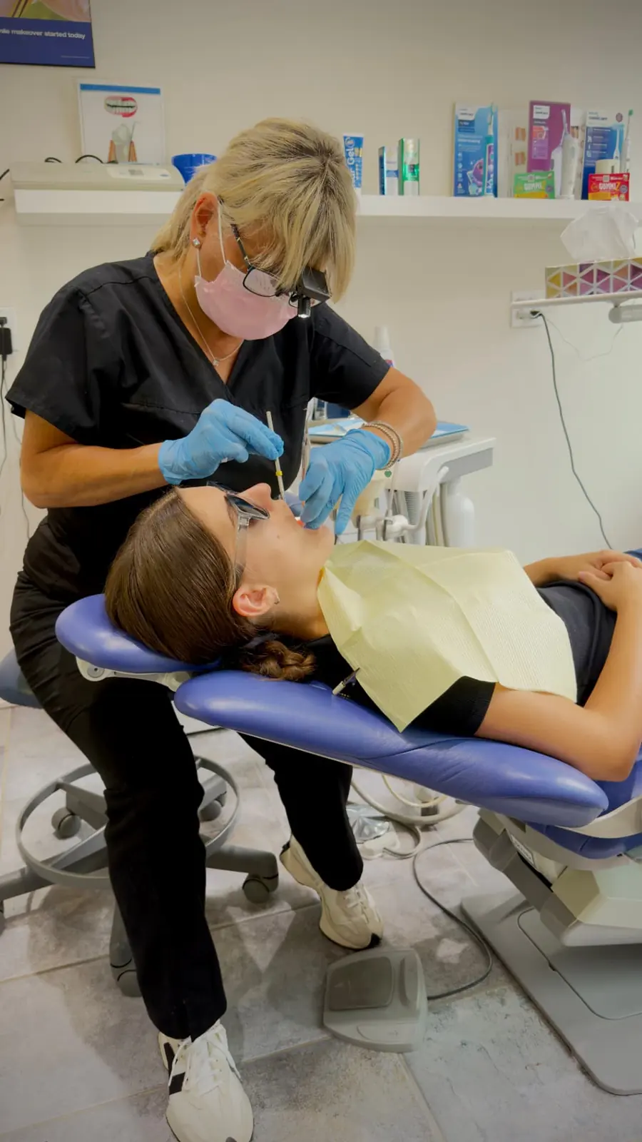Dental hygienist carefully examining a patient in the clinic