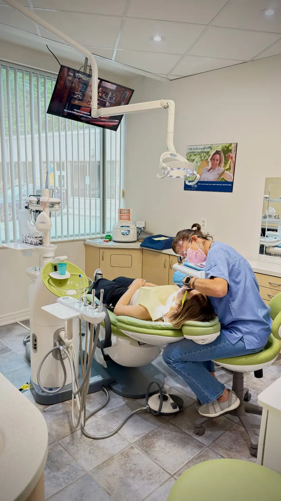 Dr. Flavia treating a patient in a bright Gateway Dental treatment room
