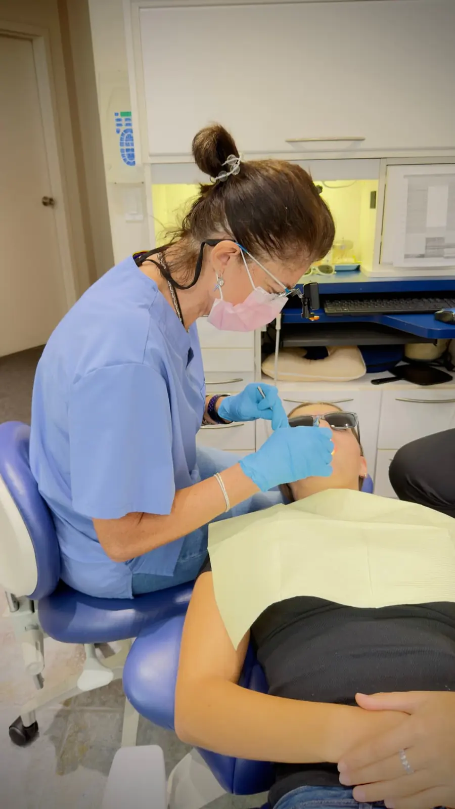 Dr. Flavia performing a close dental examination for a patient