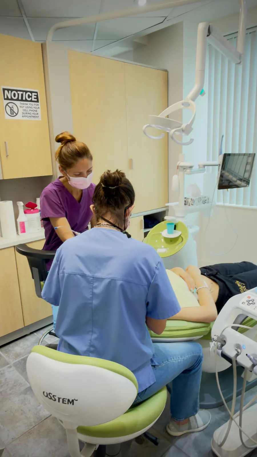 Dr. Flavia and a team member preparing care for a patient